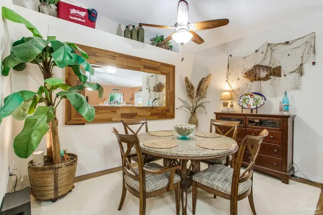 a view of a dining room with furniture and a potted plant