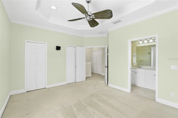 a view of an empty room and a ceiling fan