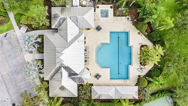 an aerial view of a house with a yard and potted plants