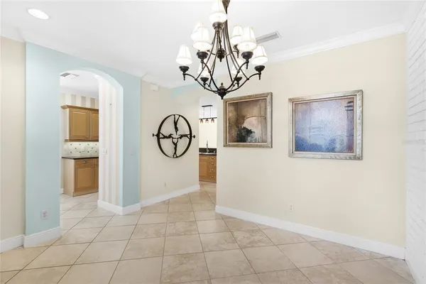 a view of a room with a chandelier and couches