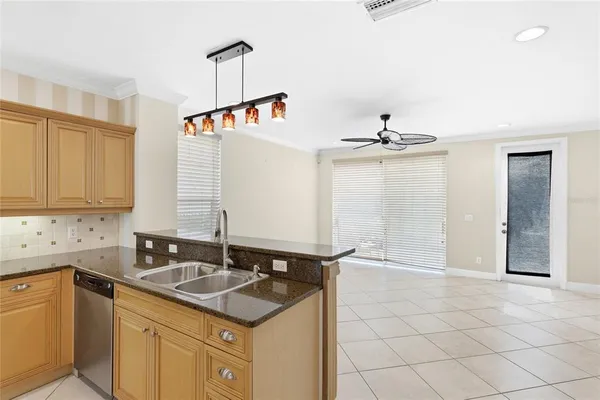 a kitchen with a sink refrigerator and cabinets