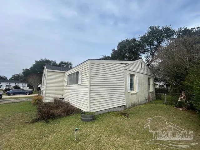 a view of a white house with a yard and garage