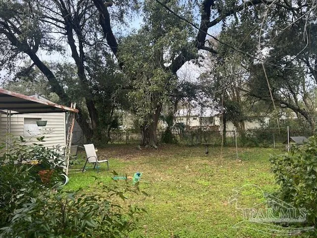 a backyard of a house with lots of green space and fountain