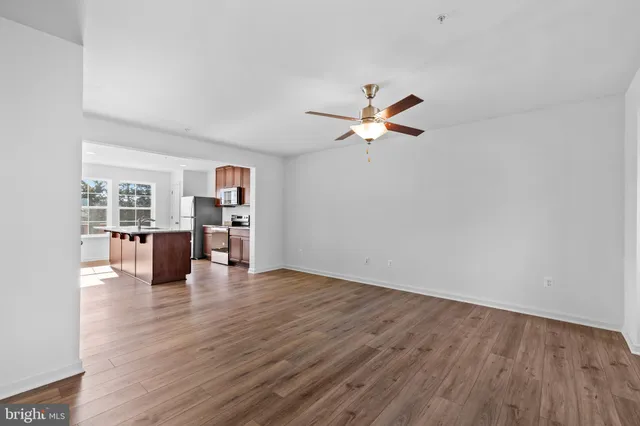 a view of a kitchen with microwave and wooden floor