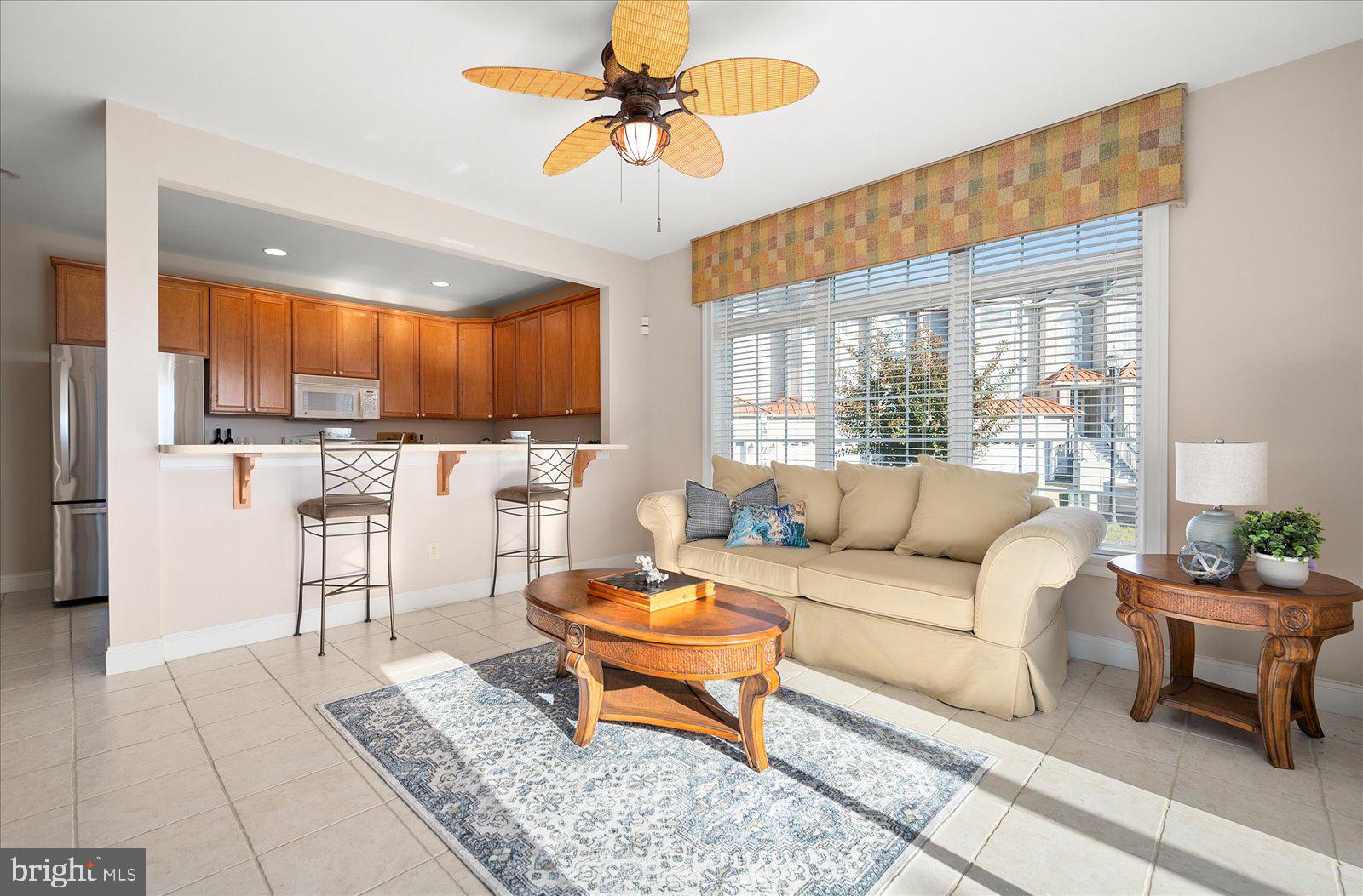 12901 Old Bridge Road, Unit PH8 2 Ocean City, MD 21842 - Photo 45 of 79 a living room with furniture a fireplace and a chandelier