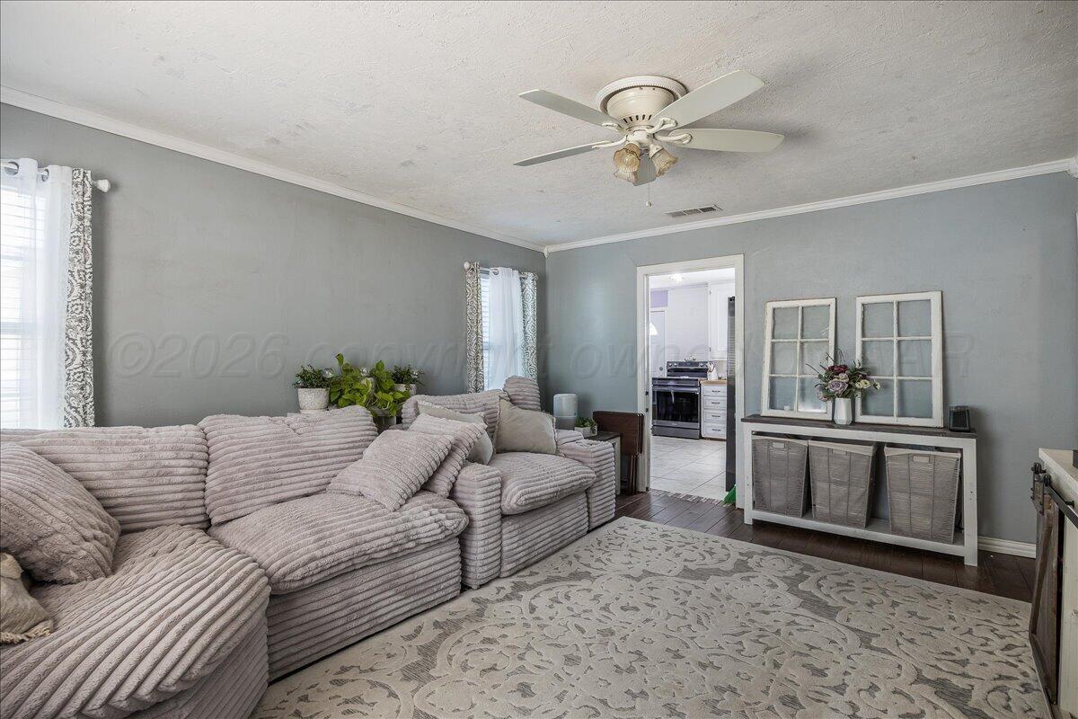 4011 Parker Street Amarillo, TX 79110 - Photo 5 of 17 a living room with furniture and a chandelier
