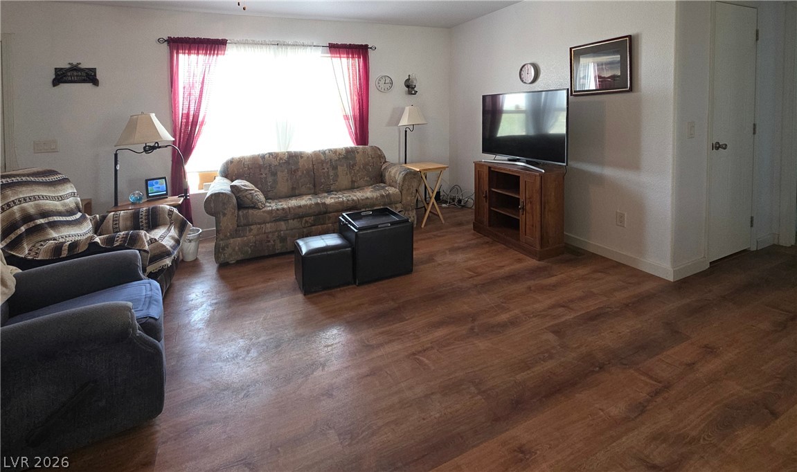 2586 South Miner Road Amargosa Valley, NV 89020 - Photo 10 of 10 Laminate flooring extends throughout this well-lit living area, perfect for daily relaxation.