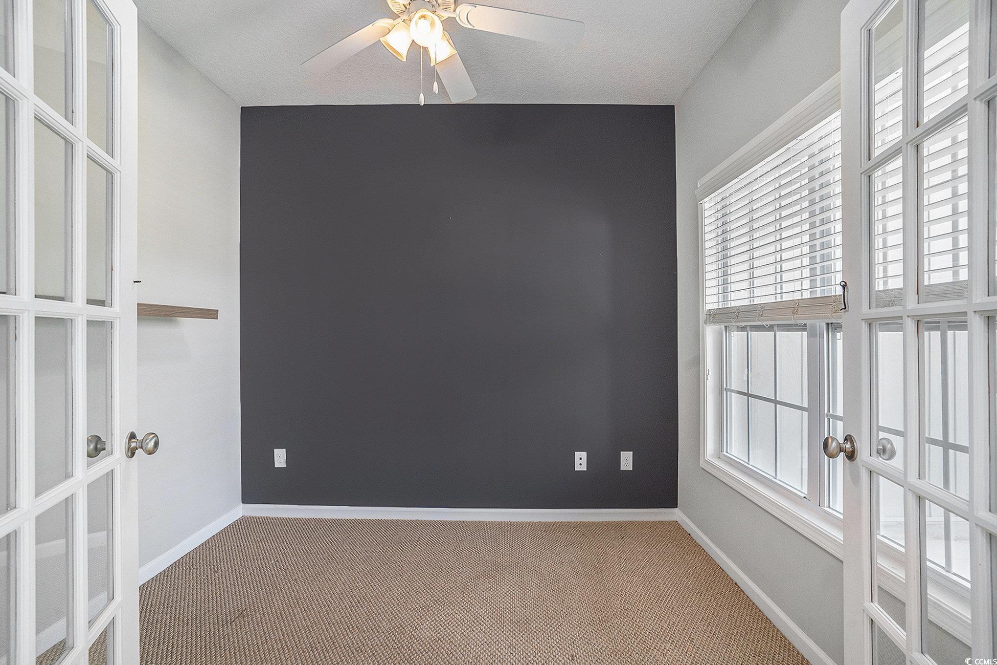 1018 Red Sky Lane, Unit 101 Murrells Inlet, SC 29576 - Photo 11 of 35 Carpeted spare room with french doors and a ceiling fan