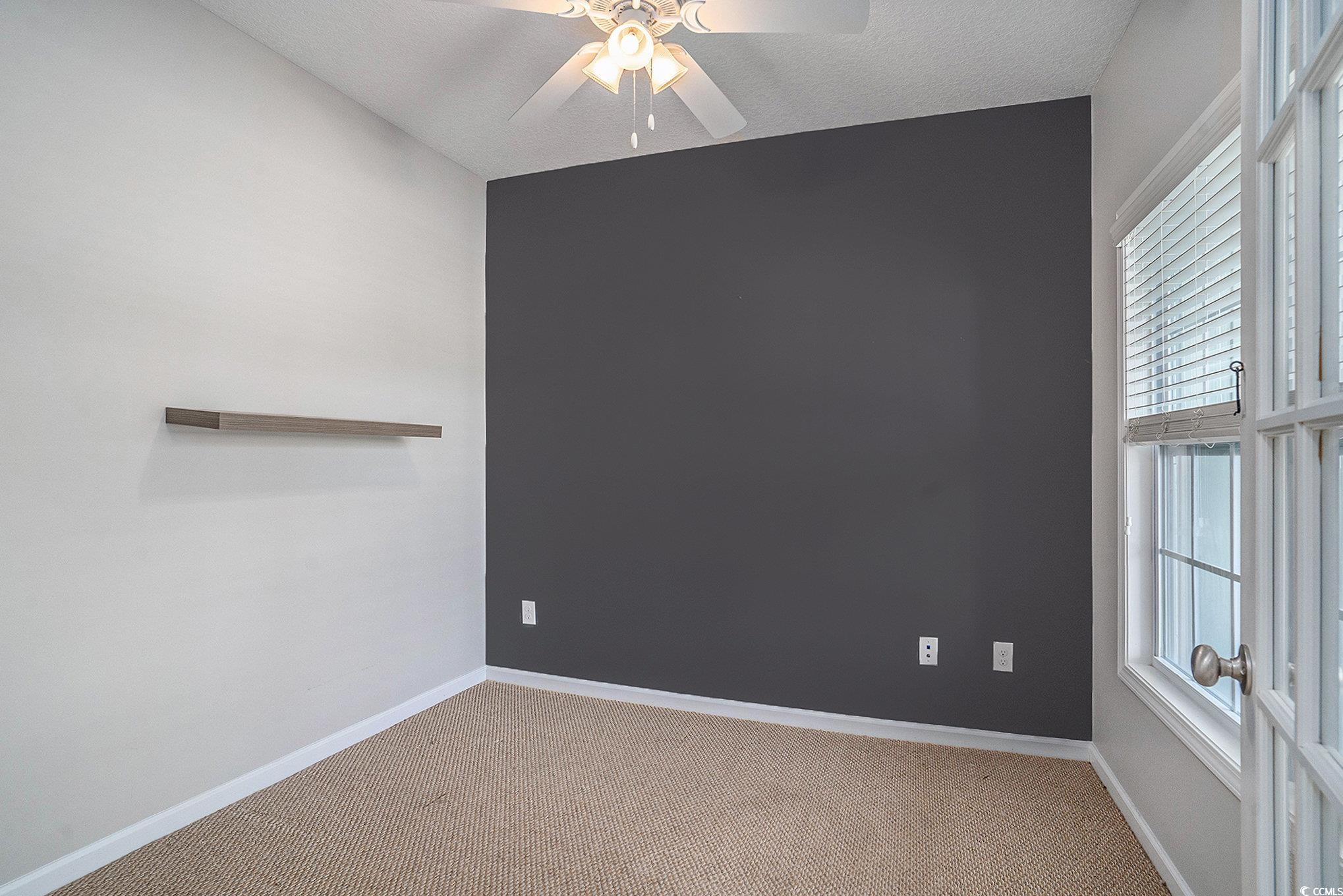 1018 Red Sky Lane, Unit 101 Murrells Inlet, SC 29576 - Photo 12 of 35 Spare room with carpet floors and ceiling fan