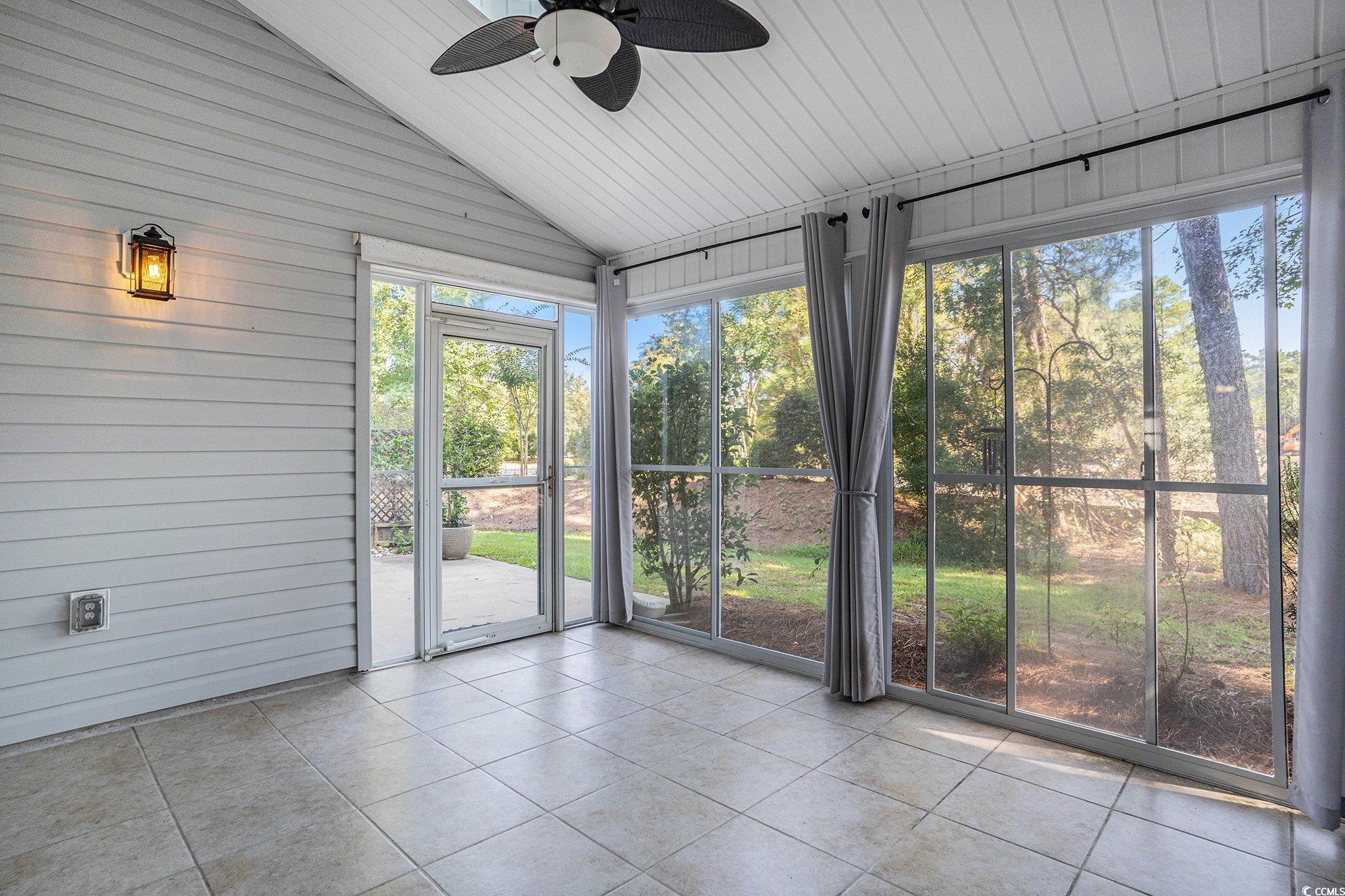 1018 Red Sky Lane, Unit 101 Murrells Inlet, SC 29576 - Photo 2 of 35 Unfurnished sunroom with lofted ceiling and ceiling fan