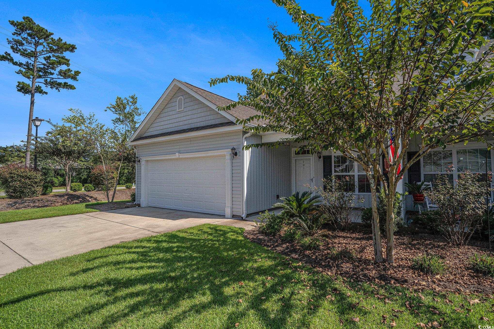 1018 Red Sky Lane, Unit 101 Murrells Inlet, SC 29576 - Photo 7 of 35 View of front of home featuring concrete driveway, a garage, and a front lawn