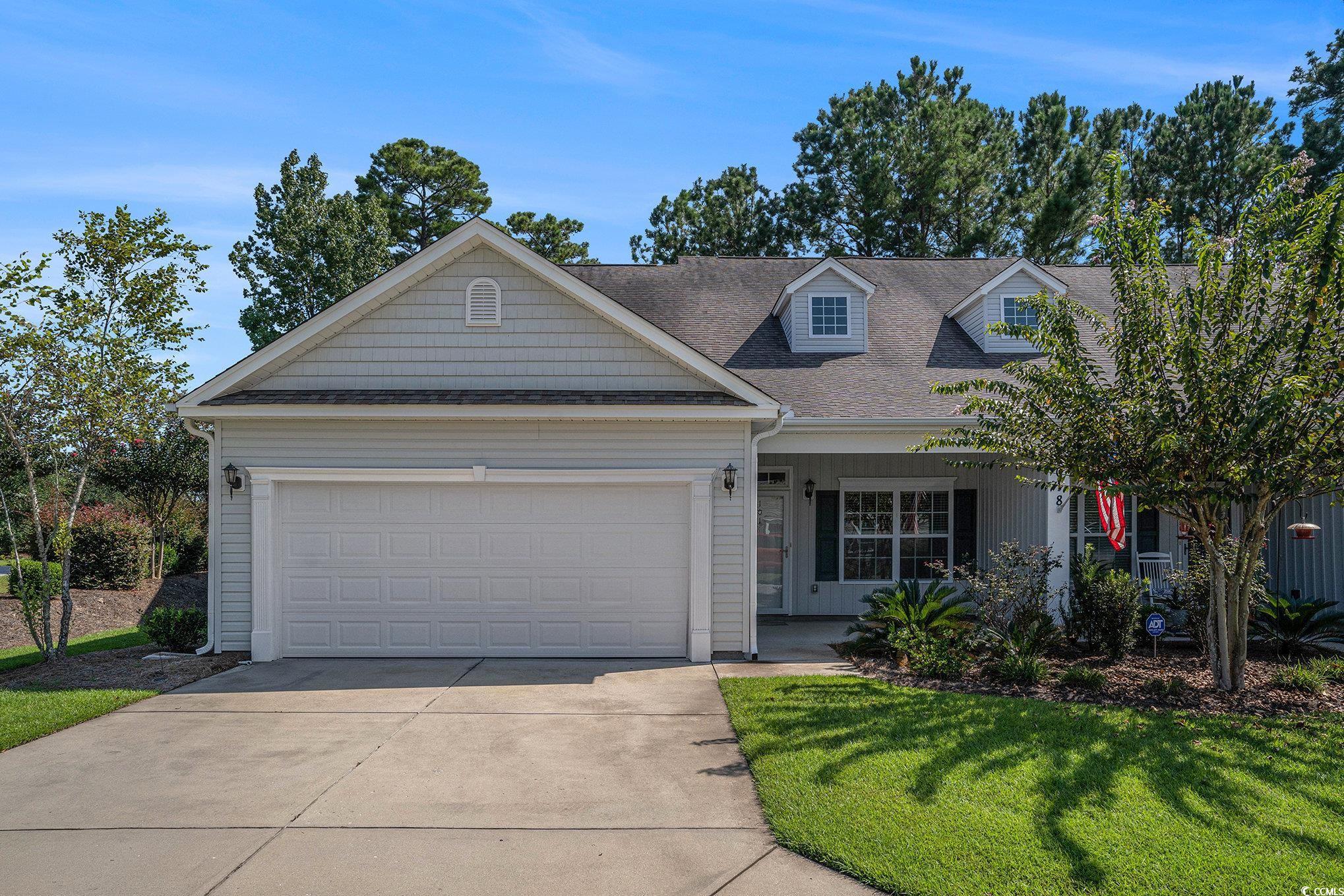 1018 Red Sky Lane, Unit 101 Murrells Inlet, SC 29576 - Photo 8 of 35 View of front facade with covered porch, an attached garage, a shingled roof, driveway, and a front lawn