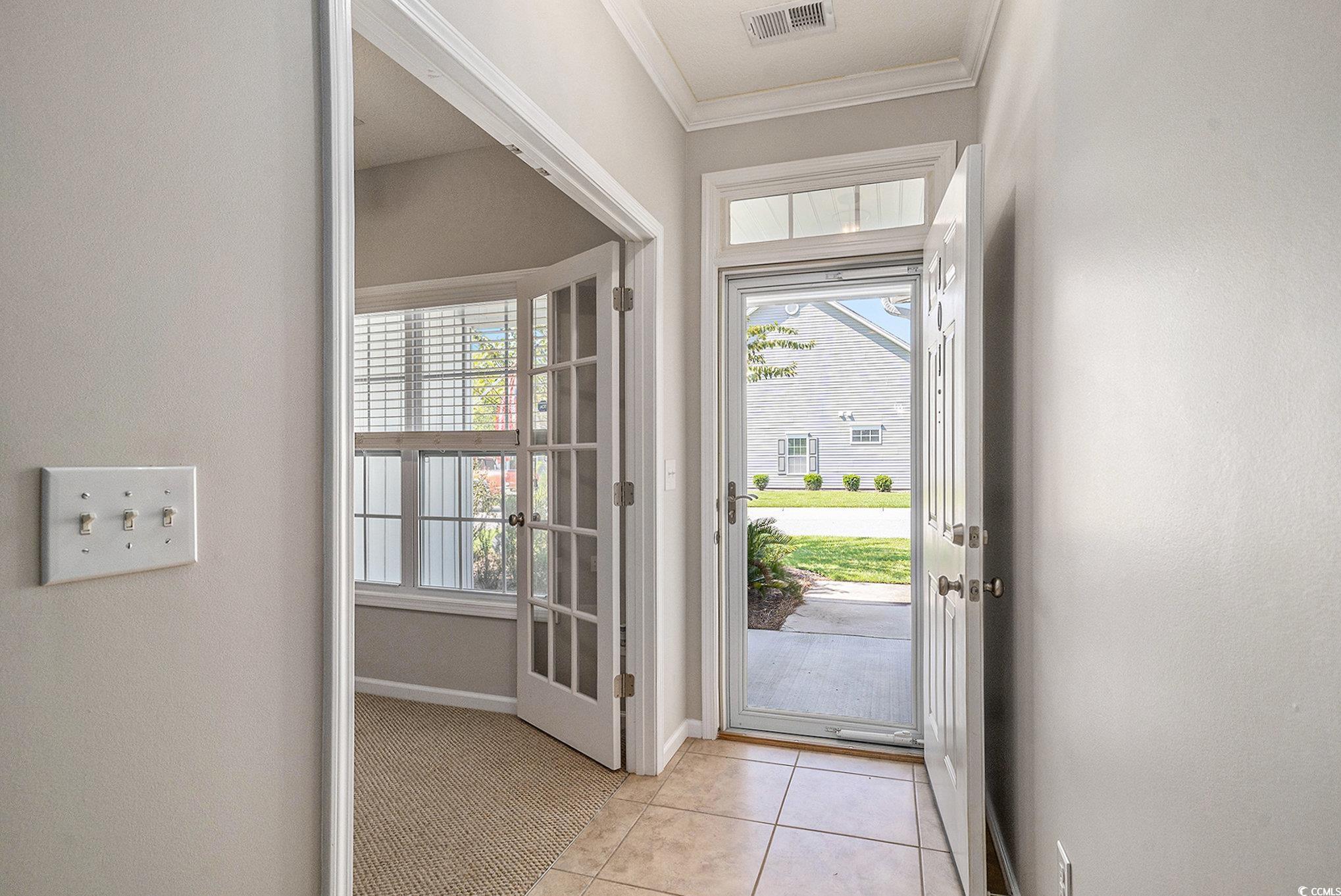 1018 Red Sky Lane, Unit 101 Murrells Inlet, SC 29576 - Photo 9 of 35 Doorway to outside with ornamental molding and tile patterned floors