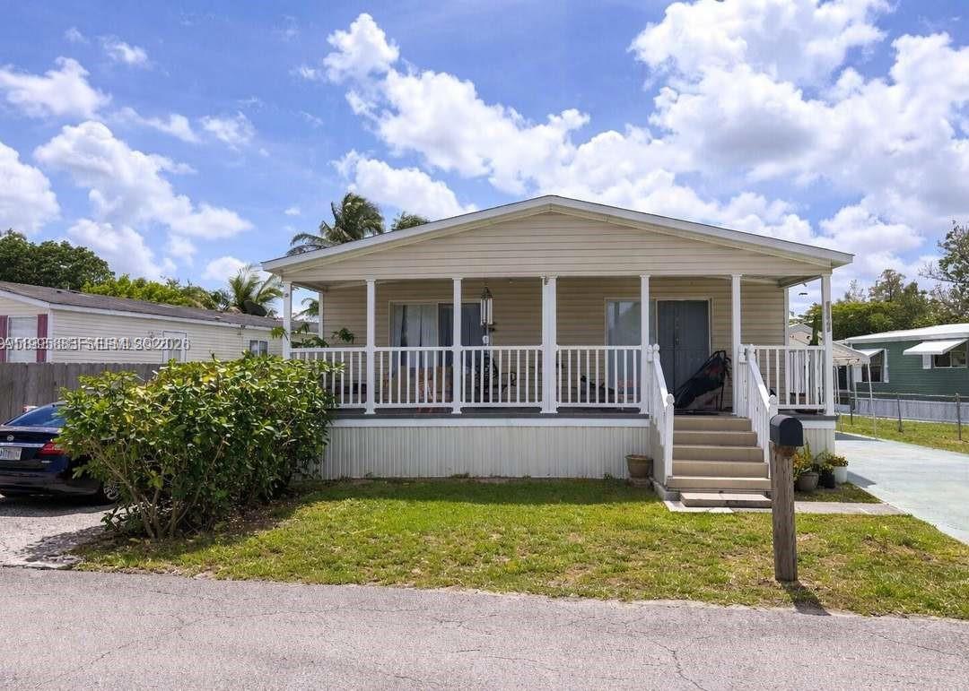 11846 Watergate Circle Boca Raton, FL 33428 - Photo 3 of 5 a front view of a house with a yard