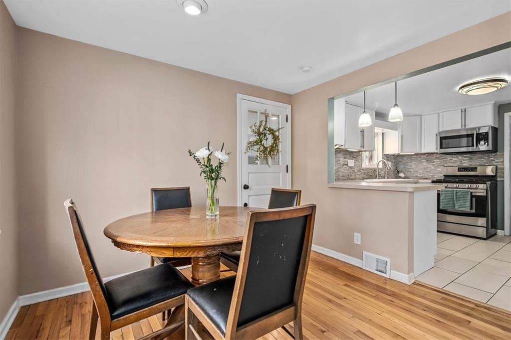 4340 Stanton Avenue Pittsburgh, PA 15201 - Photo 13 of 25 a view of a dining room with furniture and a kitchen