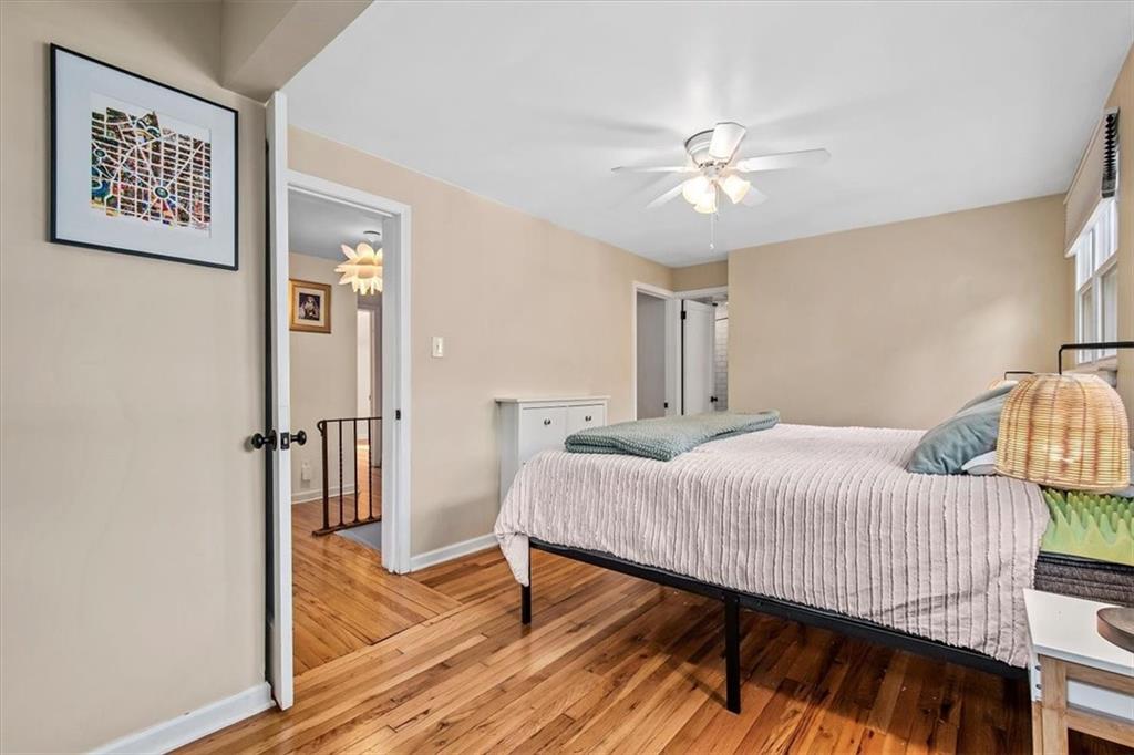 4340 Stanton Avenue Pittsburgh, PA 15201 - Photo 19 of 25 a bedroom with a bed and a chandelier