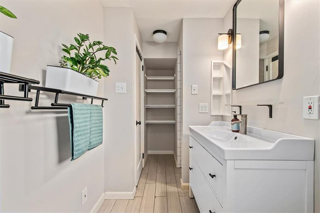 4340 Stanton Avenue Pittsburgh, PA 15201 - Photo 20 of 25 a bathroom with a sink a mirror and a shower