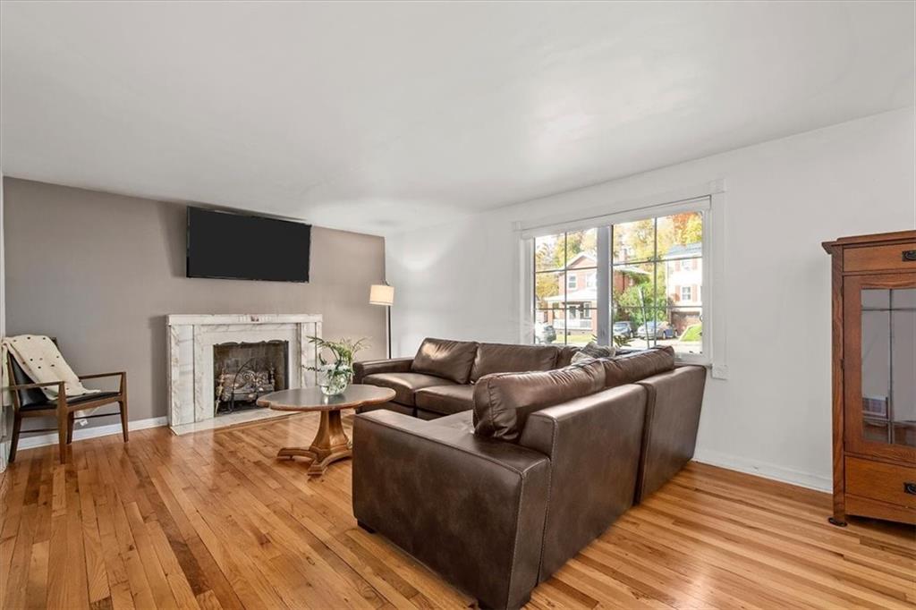 4340 Stanton Avenue Pittsburgh, PA 15201 - Photo 5 of 25 a living room with furniture a fireplace and a flat screen tv
