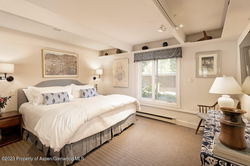 39060 Highway 82, Unit 7 Aspen, CO 81611 - Photo 11 of 17 a spacious bedroom with a bed and a large window