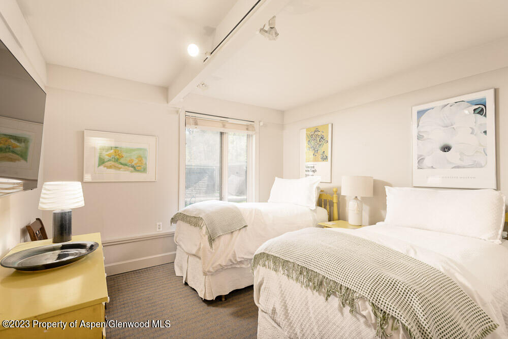 39060 Highway 82, Unit 7 Aspen, CO 81611 - Photo 13 of 17 a bedroom with a bed and a window