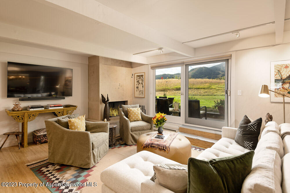 39060 Highway 82, Unit 7 Aspen, CO 81611 - Photo 3 of 17 a living room with furniture and a flat screen tv