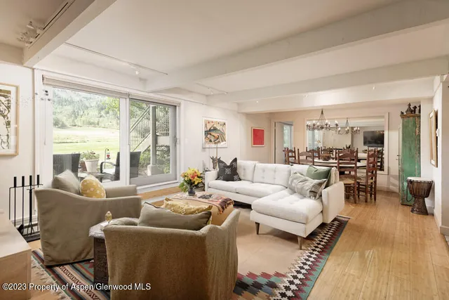 a bedroom with furniture and a large window