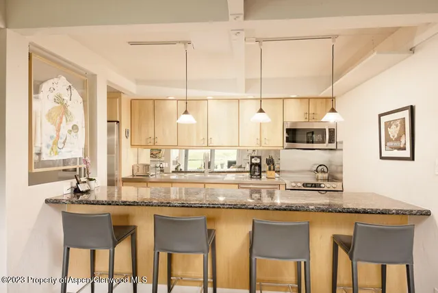a view of a chairs and table in patio with wooden floor