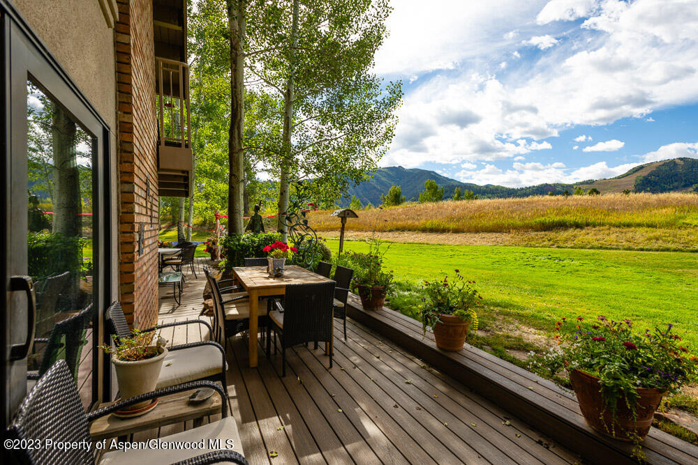 39060 Highway 82, Unit 7 Aspen, CO 81611 - Photo 7 of 17 a view of a chairs and table in patio with wooden floor