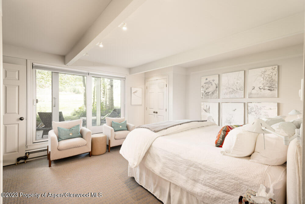 39060 Highway 82, Unit 7 Aspen, CO 81611 - Photo 8 of 17 a bedroom with a bed and a large window