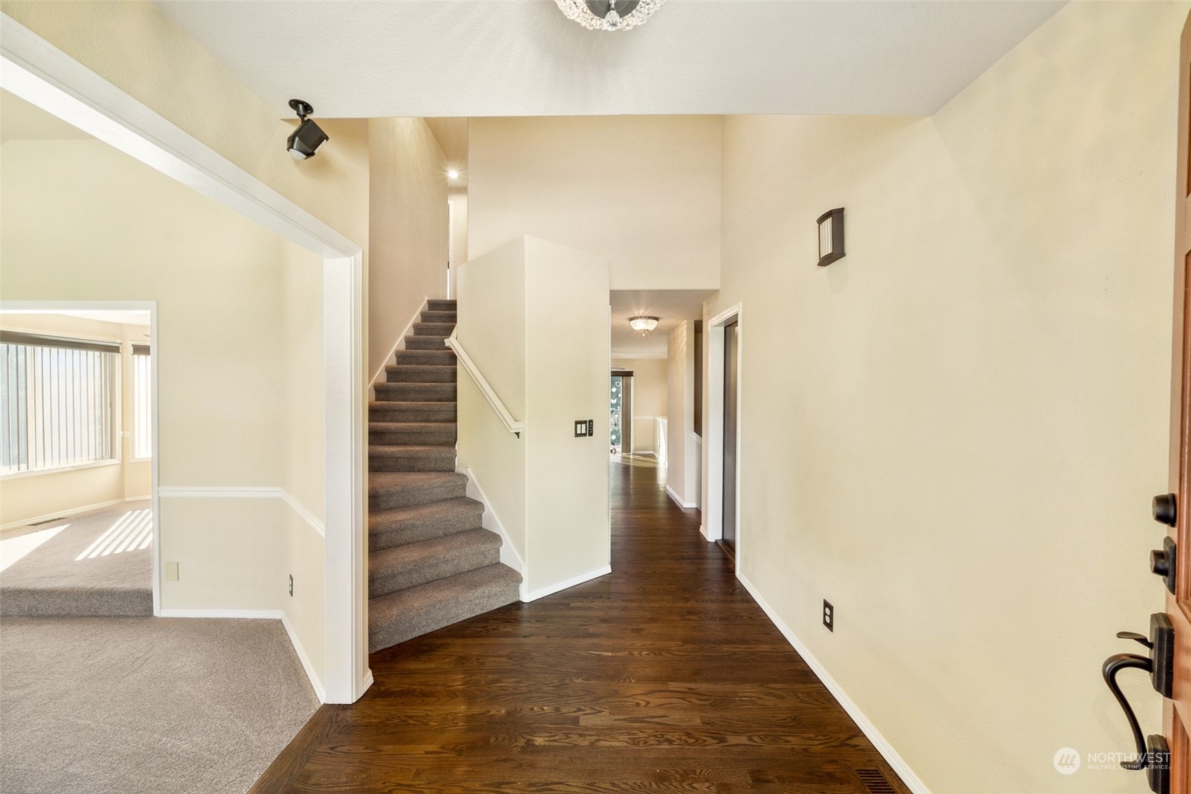 4609 Southwest 328th Place Federal Way, WA 98023 - Photo 3 of 32 a view of a hallway with wooden floor and staircase