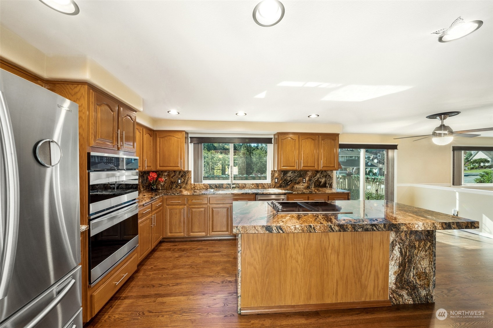 4609 Southwest 328th Place Federal Way, WA 98023 - Photo 7 of 32 a kitchen with stainless steel appliances granite countertop a stove refrigerator and cabinets