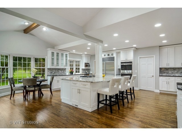 820 North Inverway Road Inverness, IL 60067 - Photo 7 of 25 a kitchen with stainless steel appliances dining table chairs and wooden floor