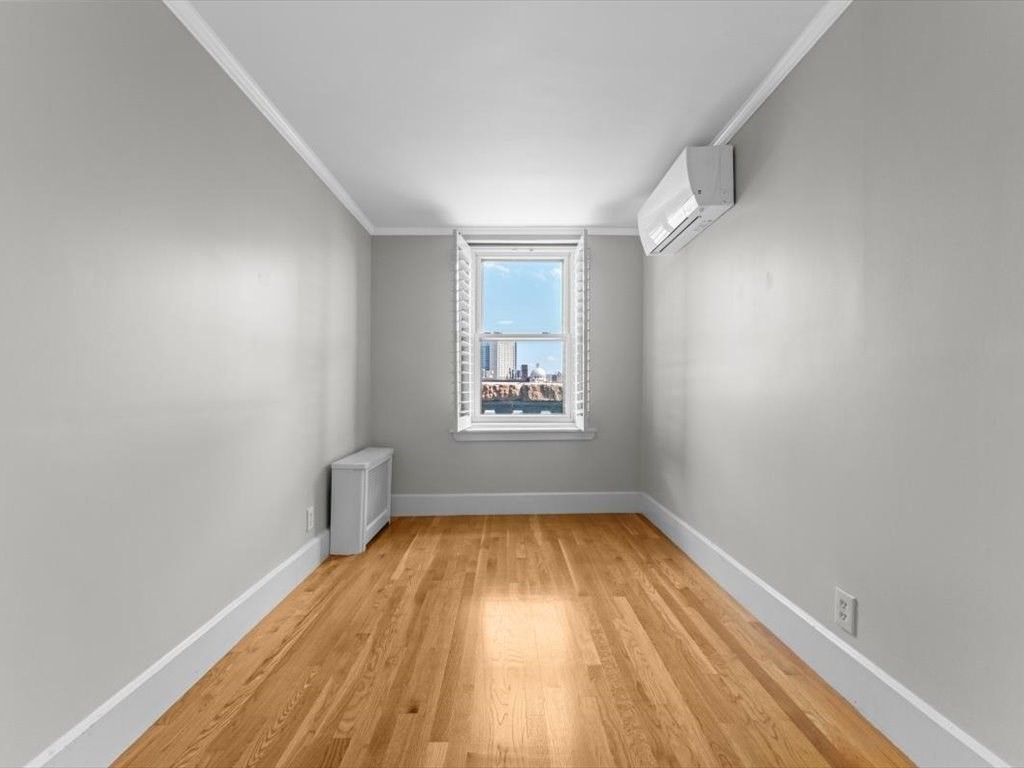 458 Beacon Street, Unit 6 Boston, MA 02115 - Photo 11 of 16 wooden floor in an empty room with a window
