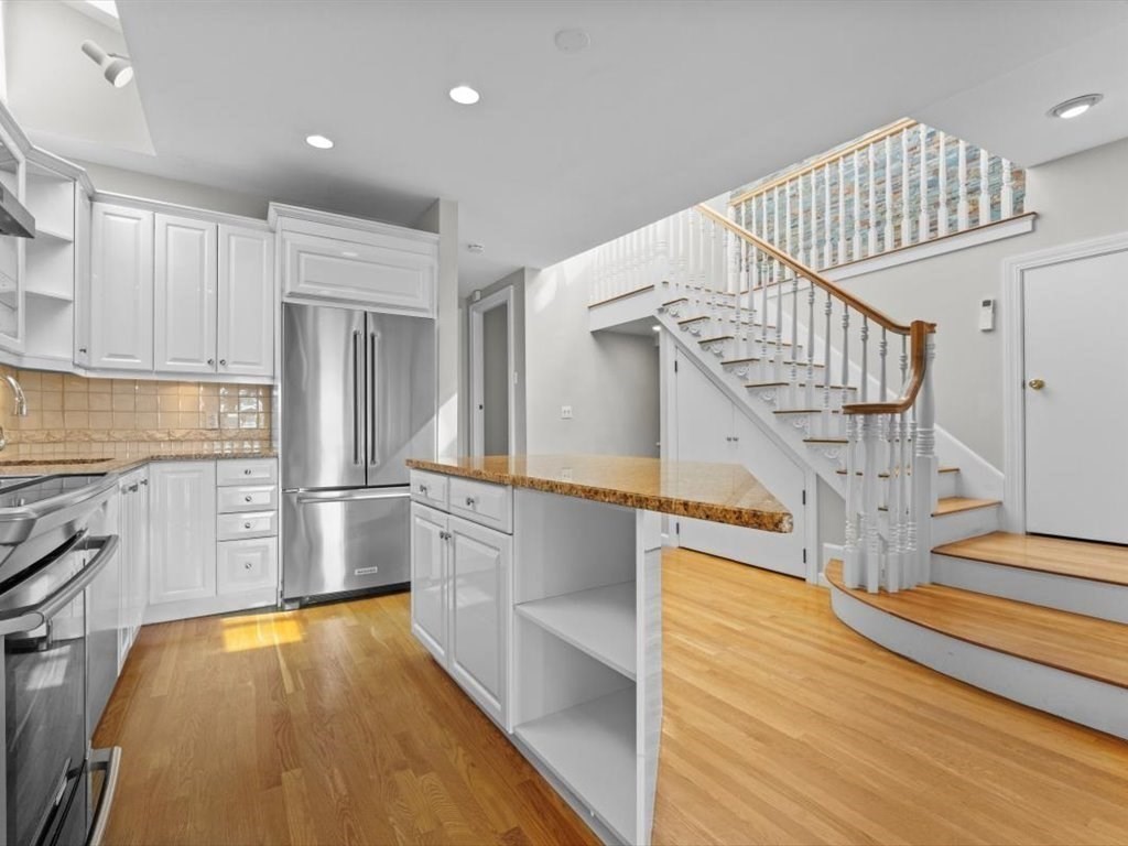 458 Beacon Street, Unit 6 Boston, MA 02115 - Photo 6 of 16 a view of entryway and kitchen with wooden floor