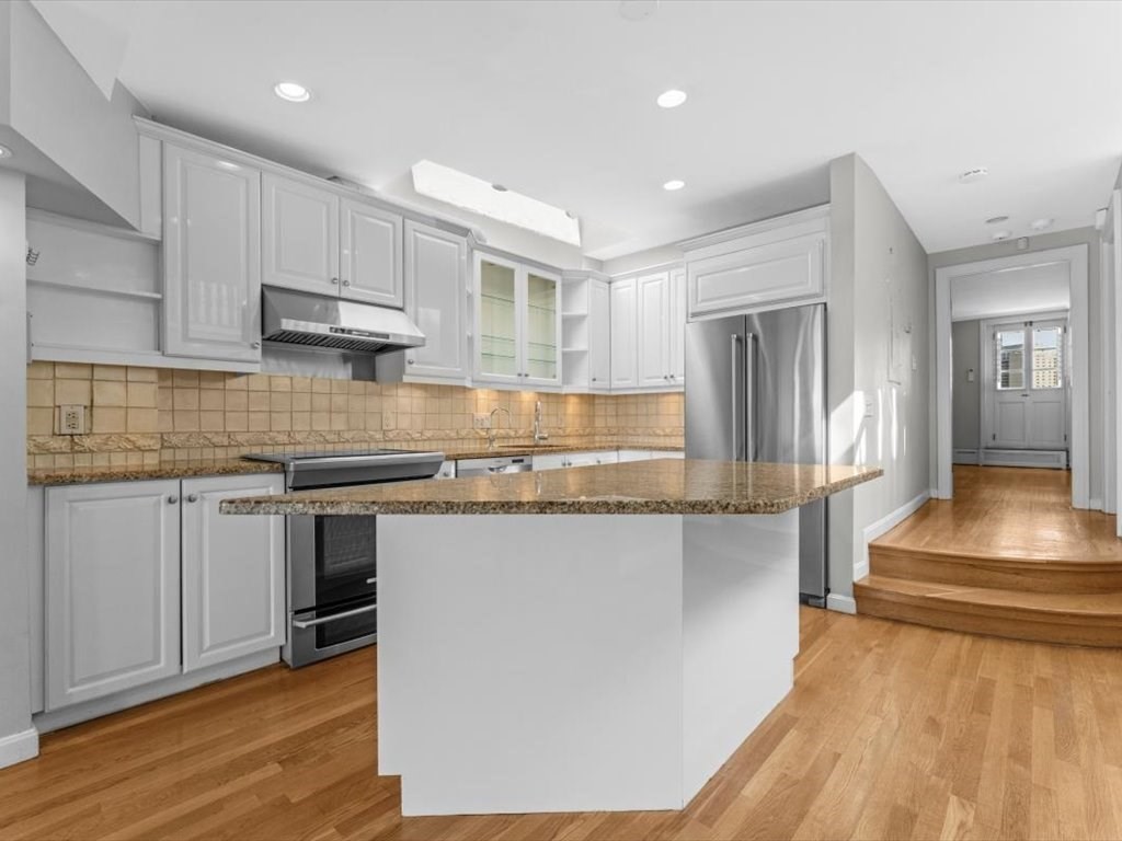 458 Beacon Street, Unit 6 Boston, MA 02115 - Photo 7 of 16 a kitchen with stainless steel appliances granite countertop a stove a sink and a refrigerator
