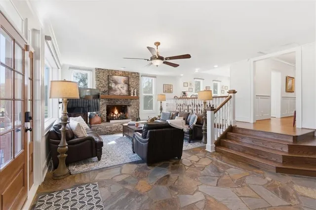 a bathroom with a granite countertop sink a large mirror a vanity and a shower