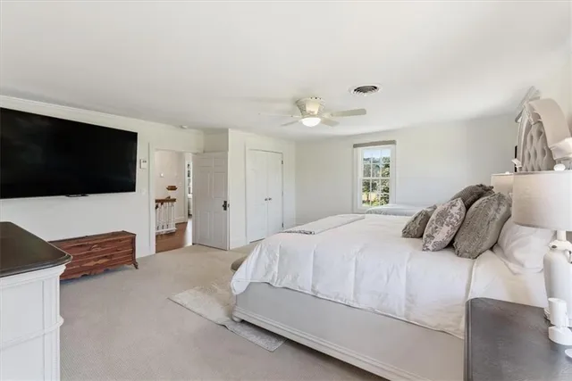 a view of a field with an ocean in the background