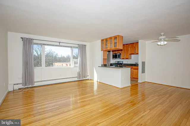 a kitchen with granite countertop a stove and a wooden floor