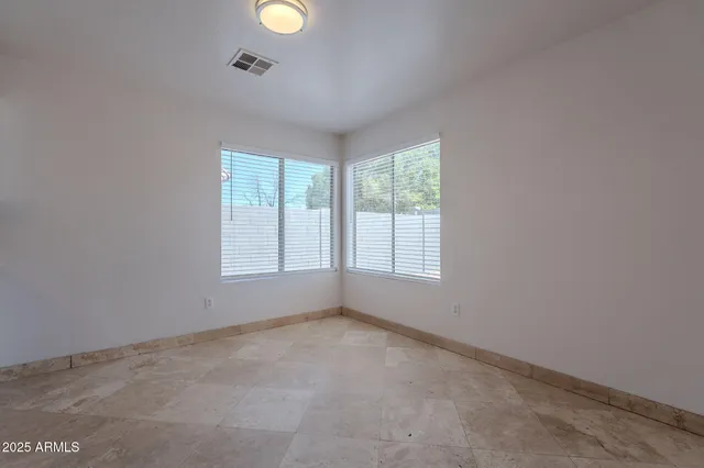 an empty room with windows and window