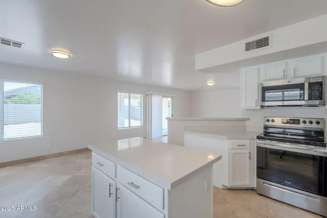a kitchen with stainless steel appliances a refrigerator and a sink