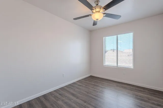 a utility room with wooden floor washer and dryer