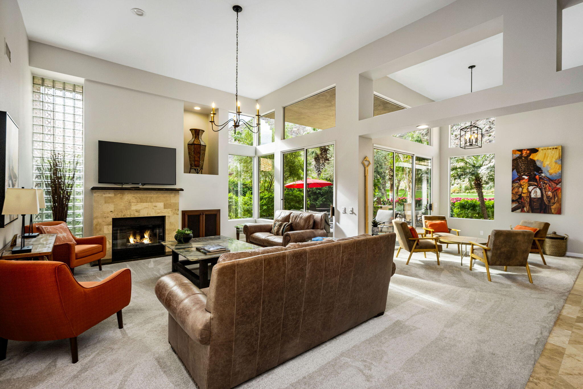 55685 Riviera La Quinta, CA 92253 - Photo 13 of 75 a living room with furniture a fireplace and a flat screen tv