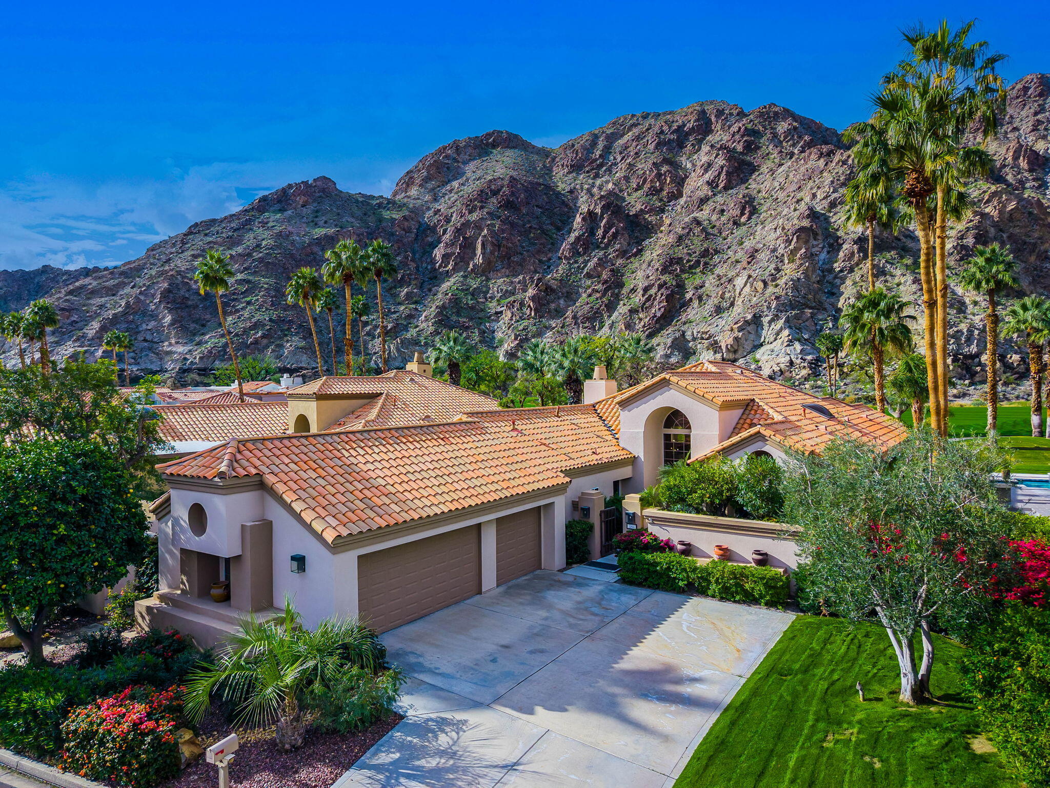 55685 Riviera La Quinta, CA 92253 - Photo 2 of 75 a aerial view of a house with a yard and potted plants
