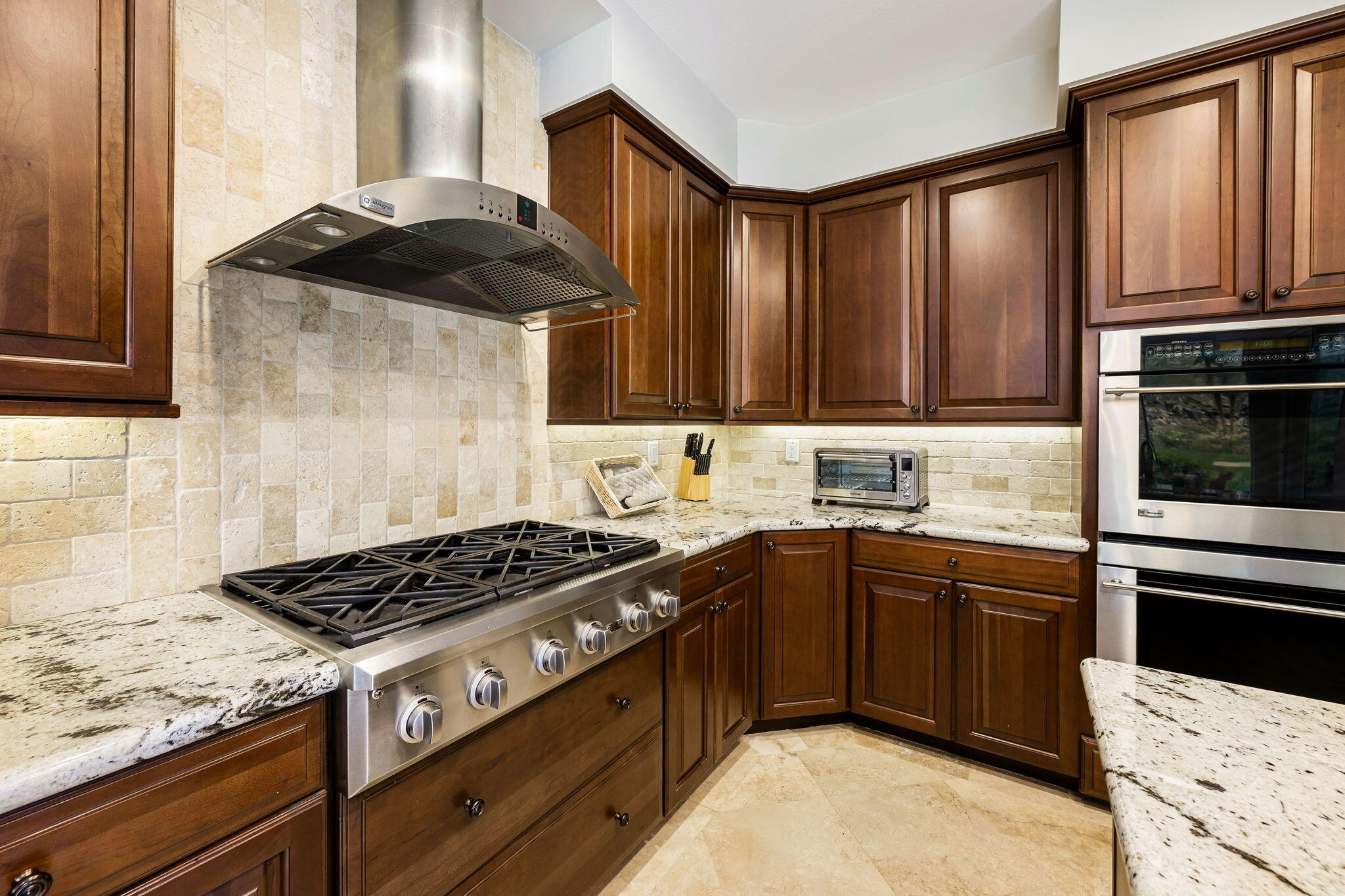 55685 Riviera La Quinta, CA 92253 - Photo 25 of 75 a kitchen with stainless steel appliances granite countertop a stove and a sink