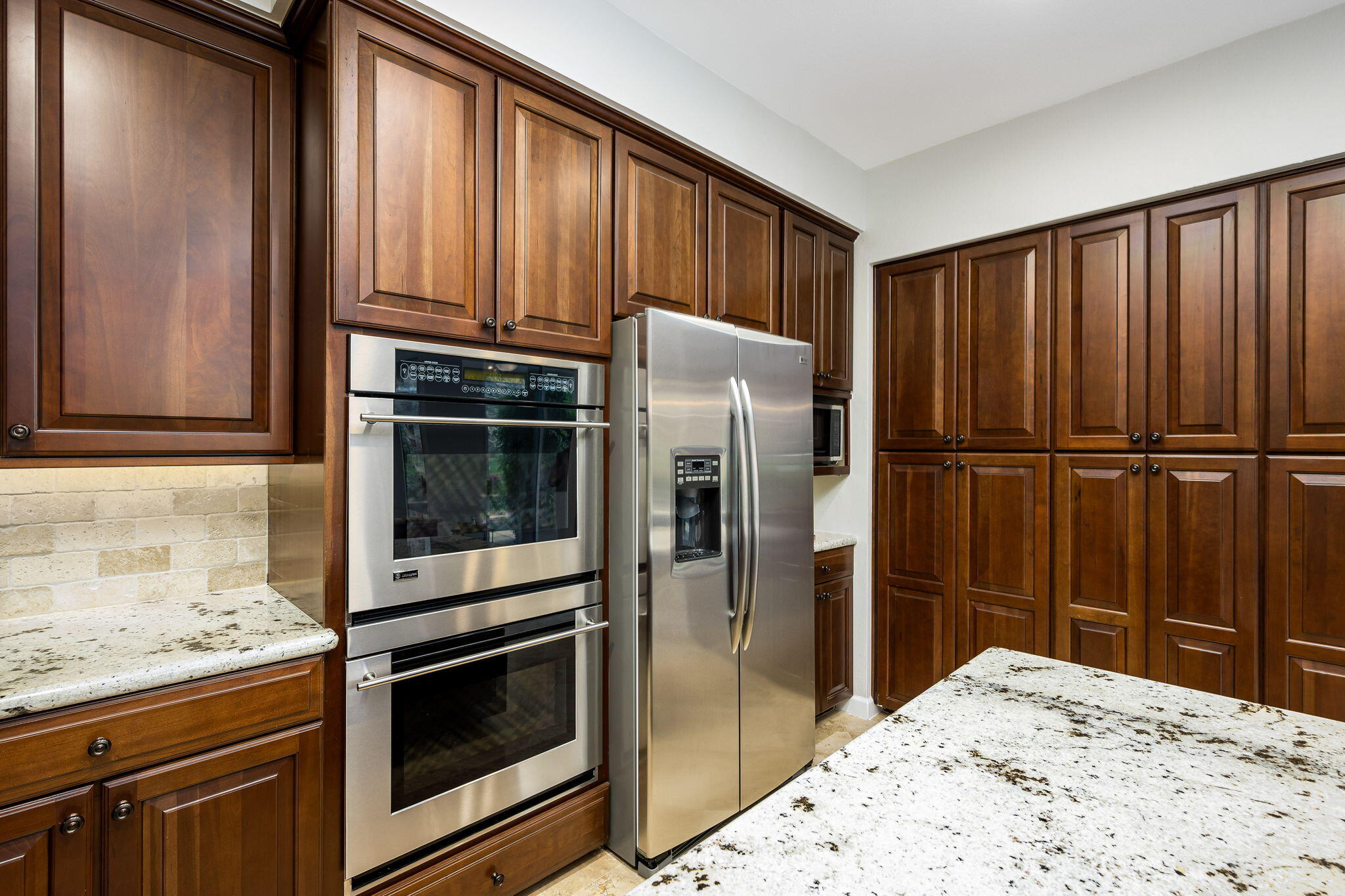55685 Riviera La Quinta, CA 92253 - Photo 26 of 75 a kitchen with granite countertop wooden cabinets and stainless steel appliances