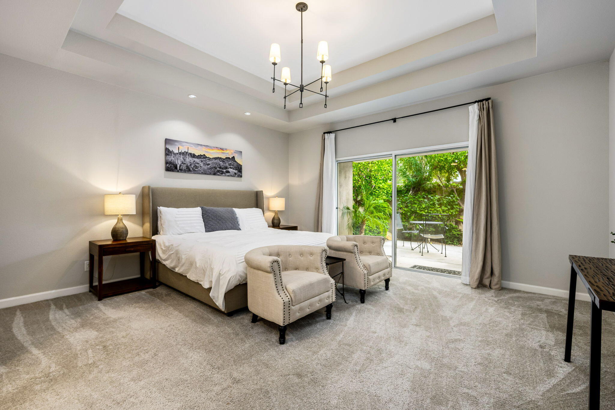 55685 Riviera La Quinta, CA 92253 - Photo 28 of 75 a spacious bedroom with a bed painting and window