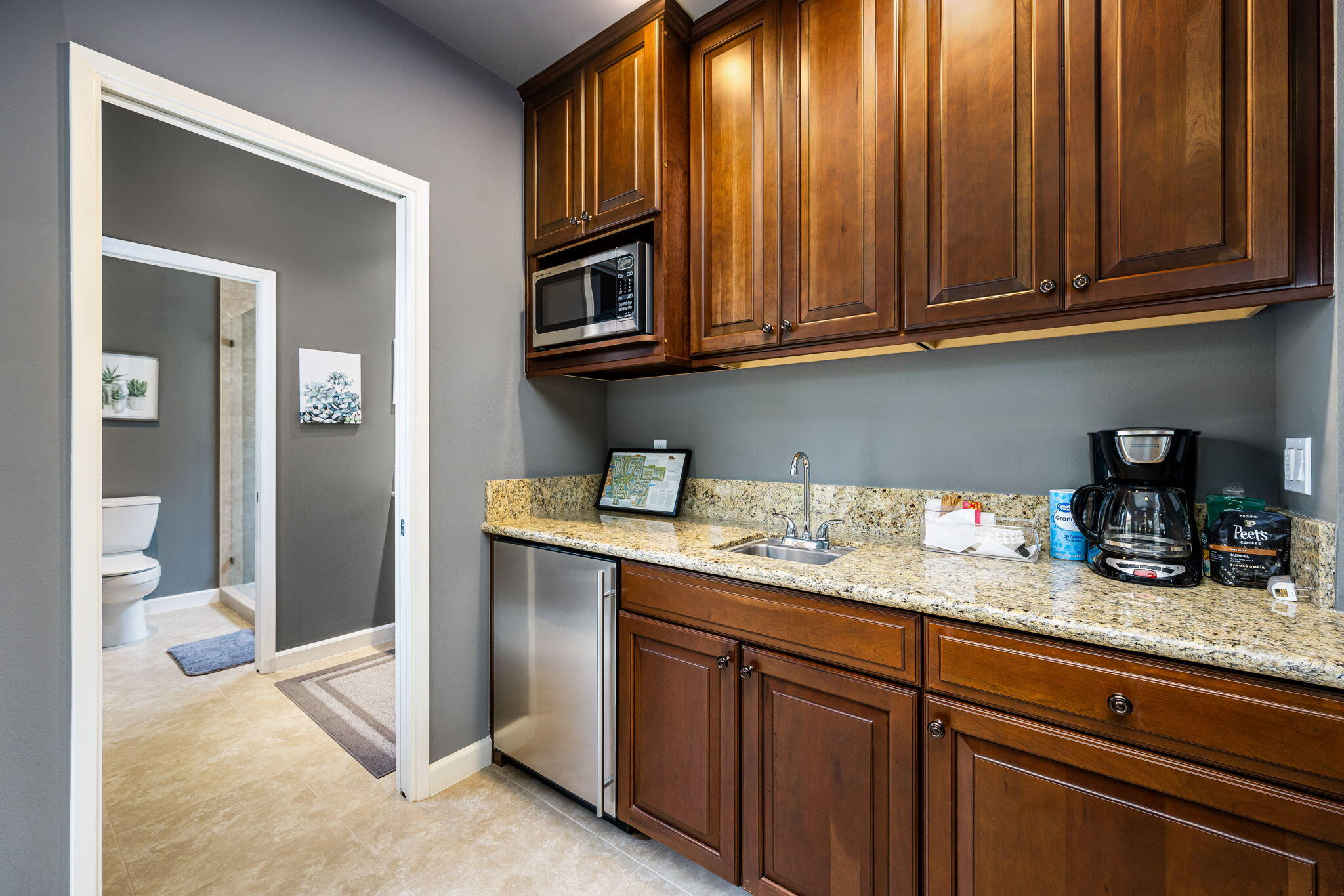 55685 Riviera La Quinta, CA 92253 - Photo 42 of 75 a kitchen with granite countertop stainless steel appliances sink and cabinets