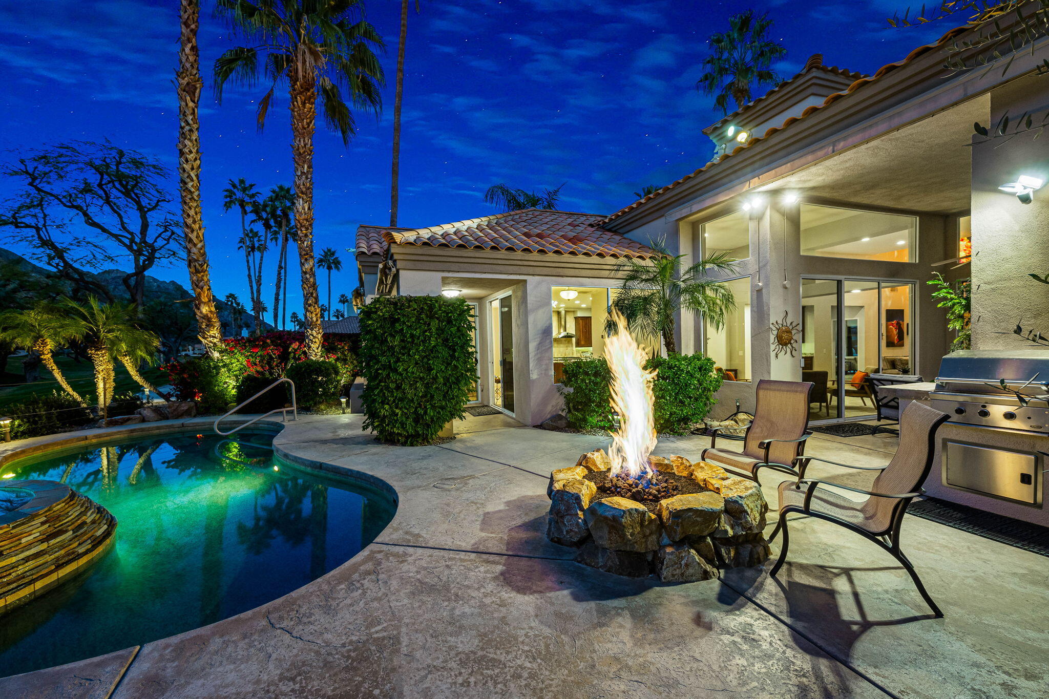 55685 Riviera La Quinta, CA 92253 - Photo 49 of 75 a view of a patio with table and chairs potted plants and large tree