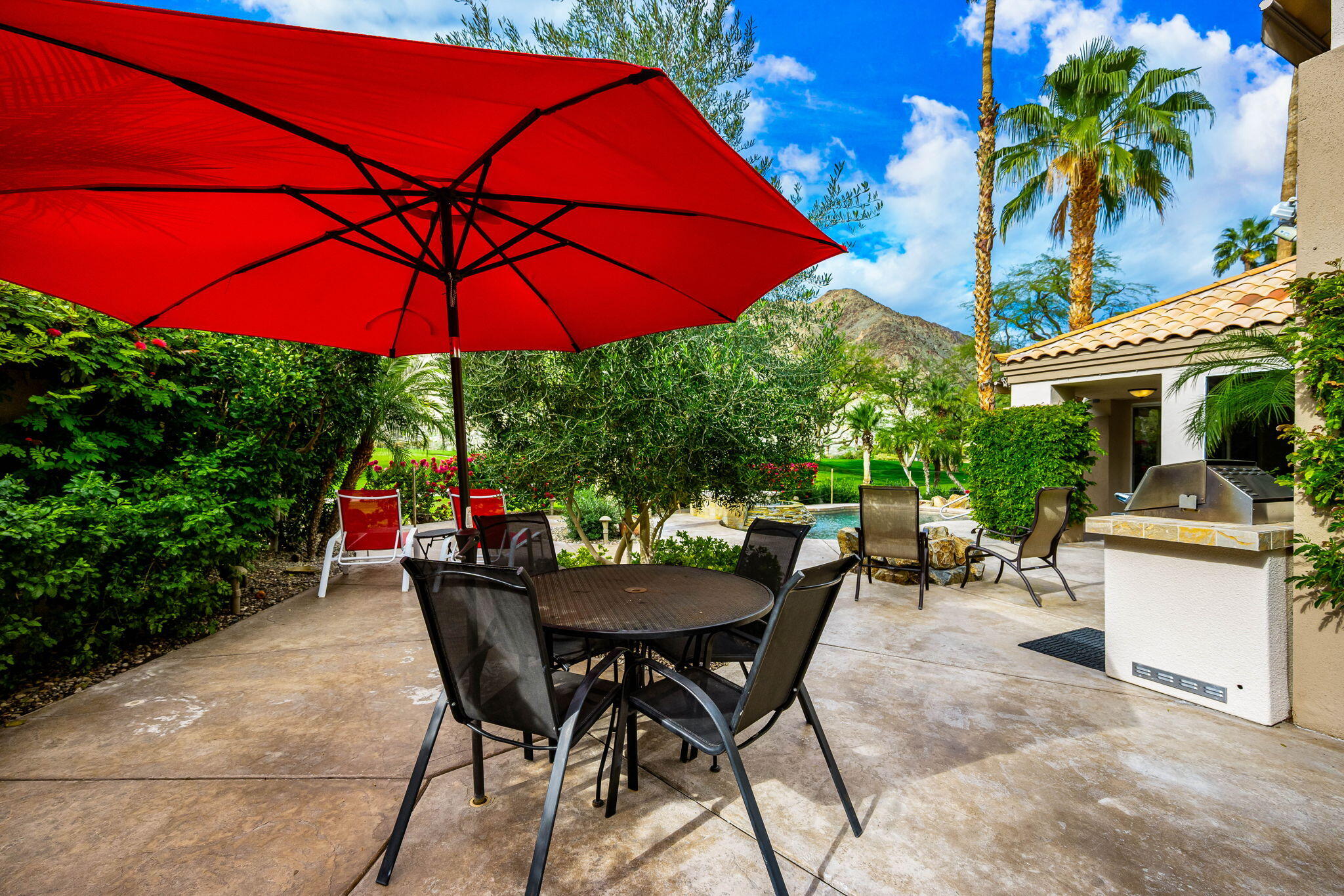 55685 Riviera La Quinta, CA 92253 - Photo 56 of 75 a view of a patio with a table and chairs under an umbrella