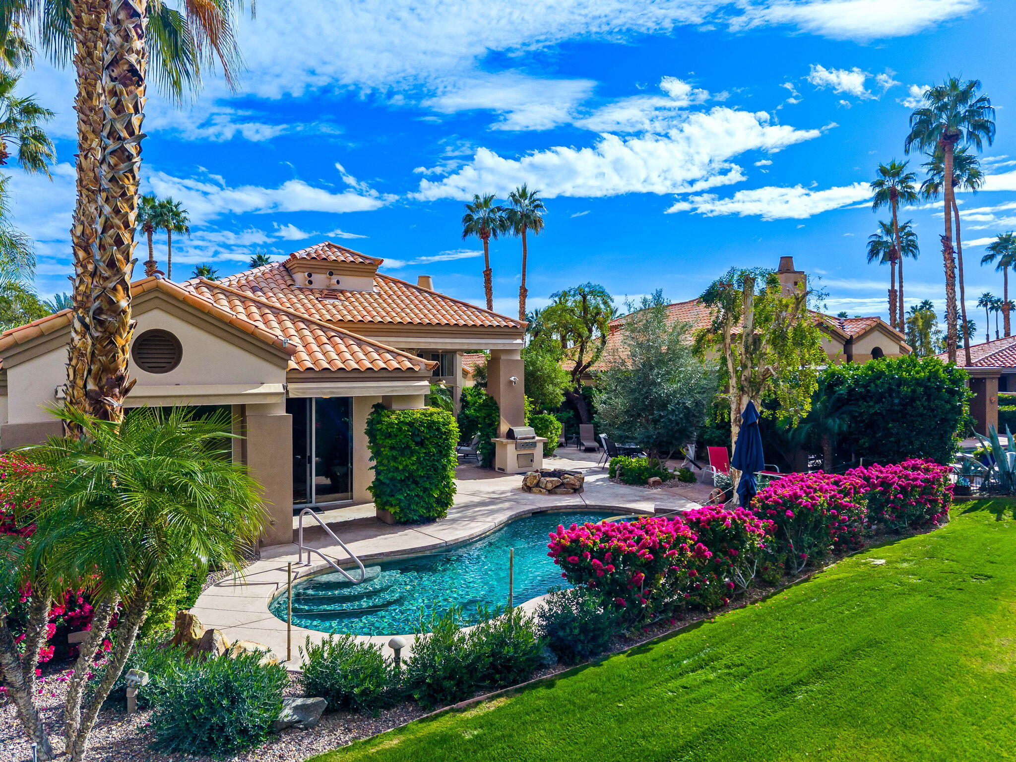 55685 Riviera La Quinta, CA 92253 - Photo 64 of 75 a view of a house with a yard and potted plants